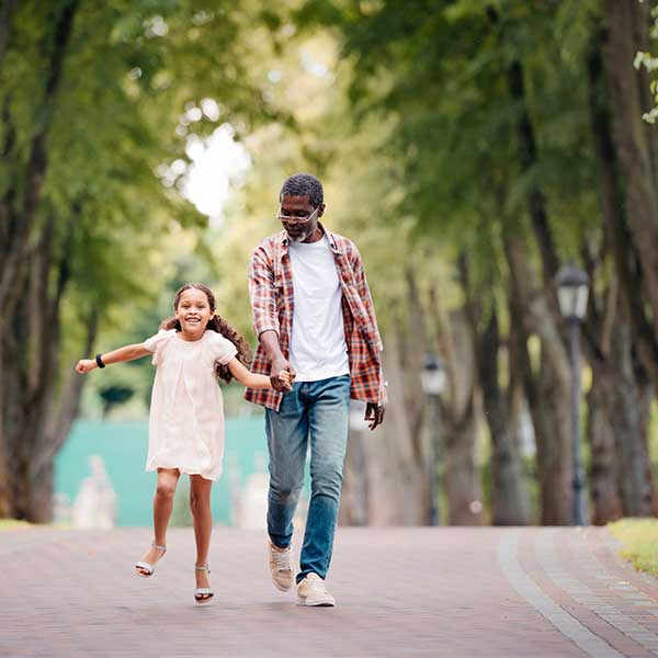 Man walking down street with grand daughter