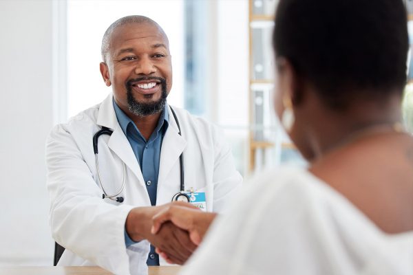 Surgeon talking with patient in office