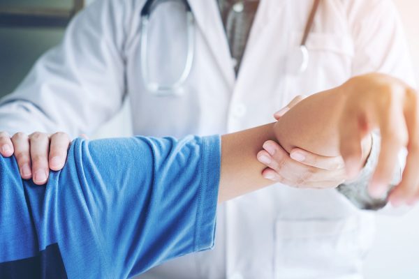 Doctor Surgeon showing patient shoulder range of motion